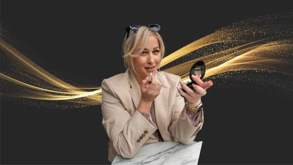 Agata applying lipstick with golden light streaks behind her